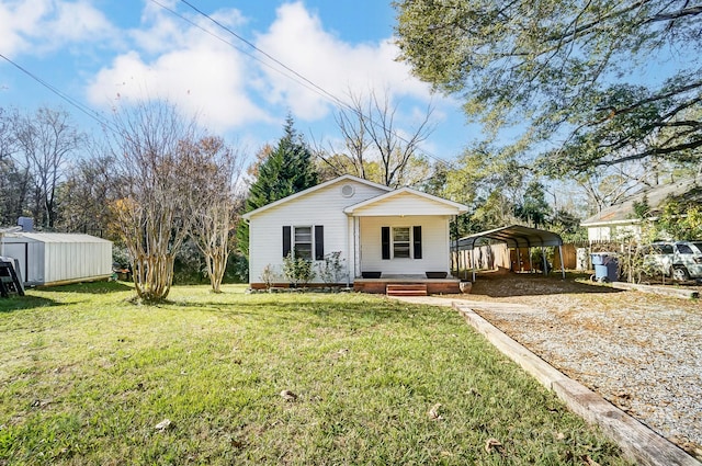 view of front of house featuring a porch, a front yard, a shed, and a carport