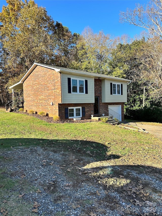 raised ranch with a front yard and a garage