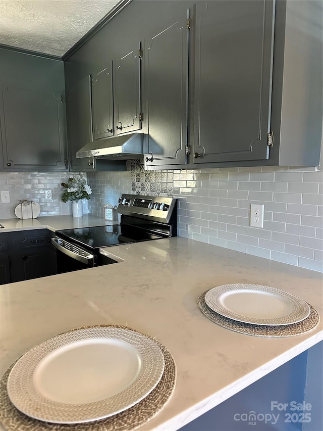 kitchen featuring gray cabinetry, a textured ceiling, stainless steel range with electric cooktop, and backsplash