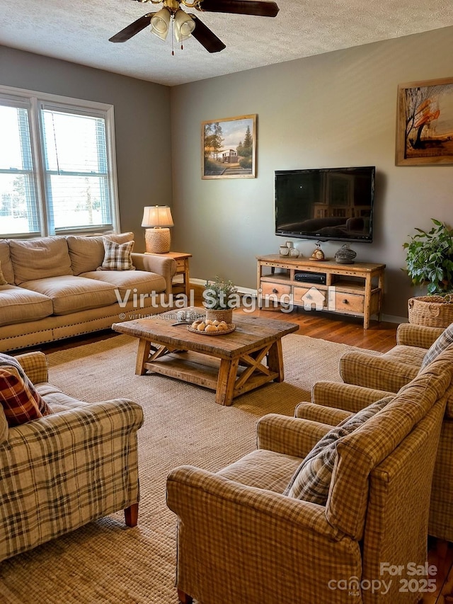 living room with ceiling fan, hardwood / wood-style floors, and a textured ceiling