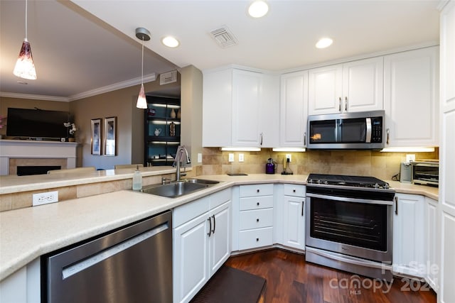 401 N Church St Unit 406, Charlotte, NC 28202 - kitchen with stainless steel appliances, a sink, ornamental molding, backsplash, and hanging light fixtures