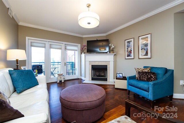 living room with a fireplace, dark hardwood / wood-style floors, and crown molding