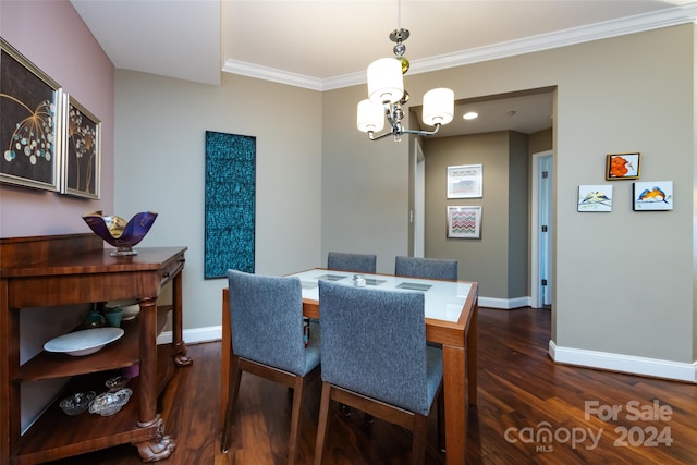 dining space featuring crown molding, dark wood-type flooring, and a notable chandelier