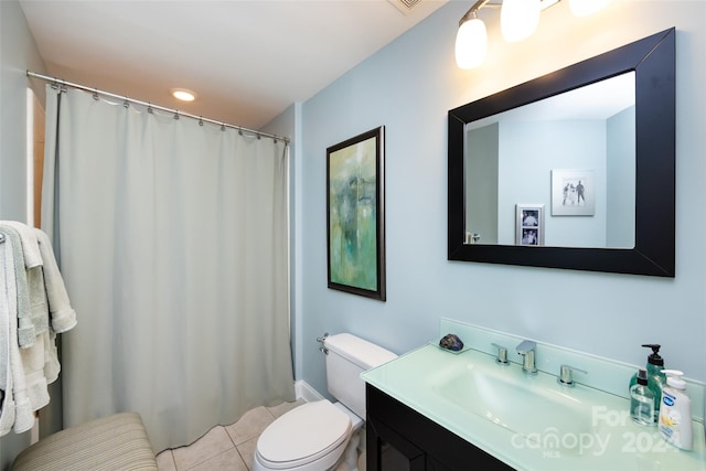 bathroom featuring tile patterned flooring, vanity, and toilet