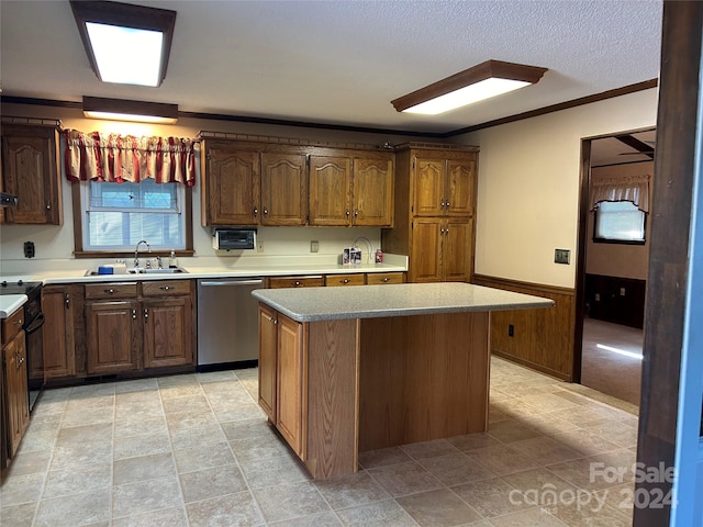 kitchen with sink, ornamental molding, a kitchen island, black range, and dishwasher