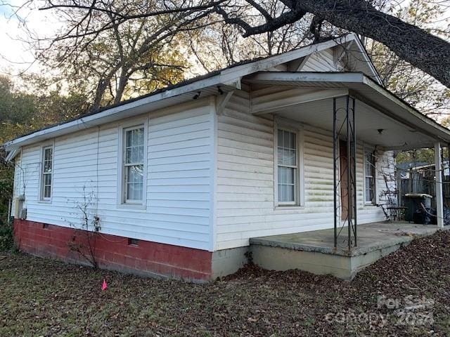 view of side of home featuring a porch