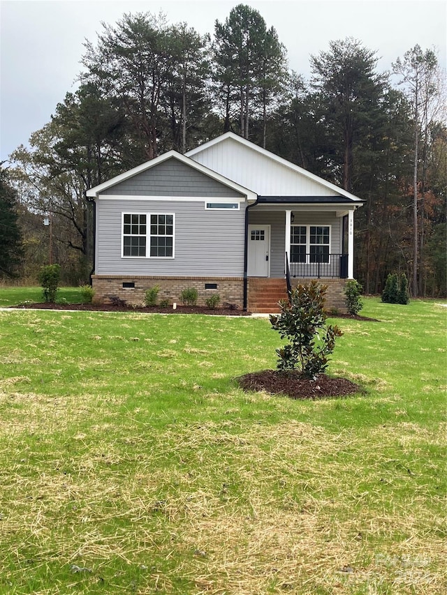 view of front of property with a porch and a front yard