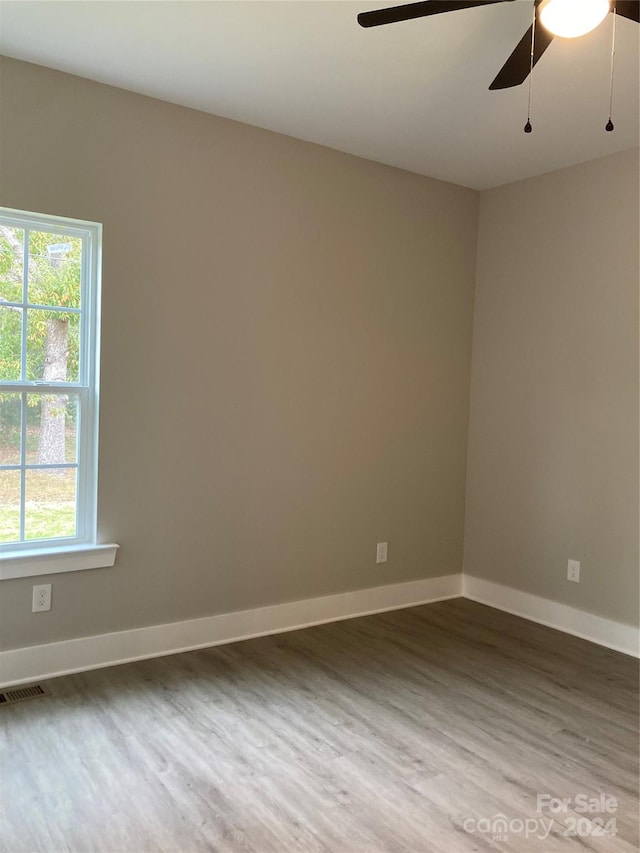 unfurnished room with hardwood / wood-style flooring and ceiling fan