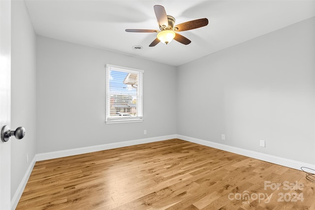 empty room with ceiling fan and light wood-type flooring