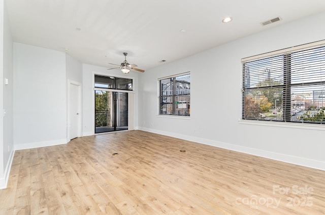 spare room featuring ceiling fan and light hardwood / wood-style flooring