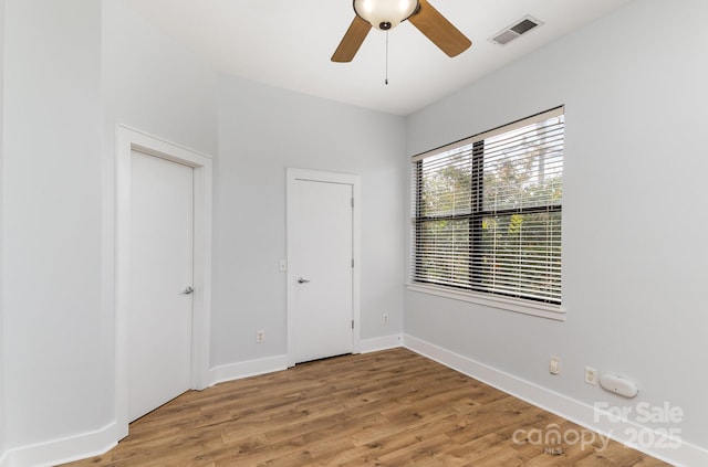 unfurnished bedroom with ceiling fan and hardwood / wood-style flooring