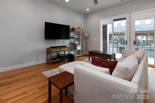 living room with ceiling fan and wood-type flooring