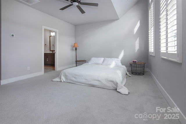 bedroom with light carpet, connected bathroom, and ceiling fan