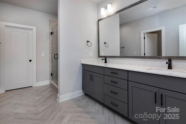 bathroom with vanity, parquet flooring, and walk in shower