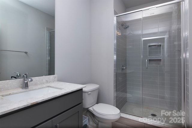 bathroom with vanity, toilet, and walk in shower