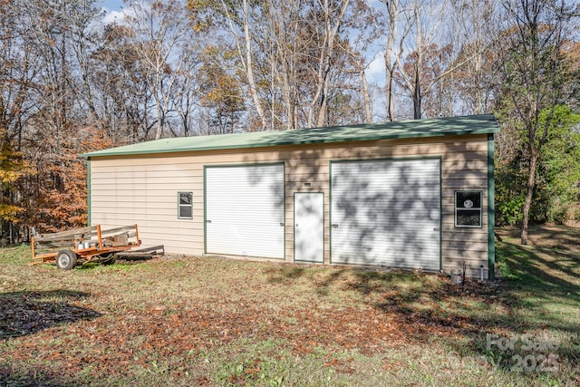 view of outbuilding with a garage and a yard