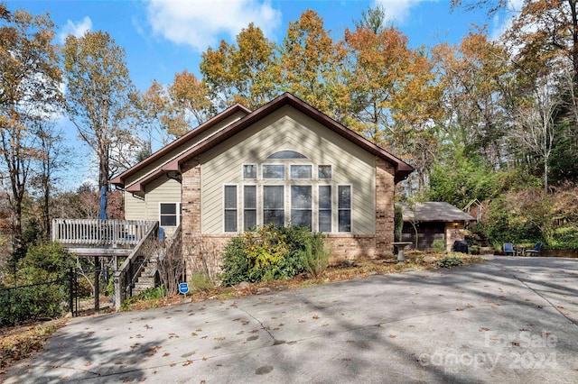 view of property exterior with a wooden deck