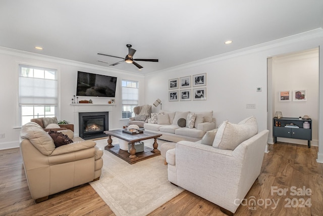 living room with ornamental molding, a healthy amount of sunlight, and wood-type flooring