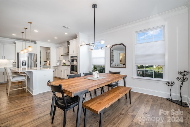 dining room featuring wood-type flooring and crown molding