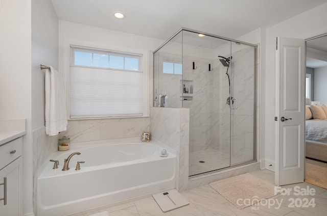 bathroom with vanity and separate shower and tub