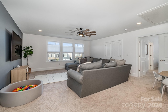 living room with ceiling fan and light colored carpet