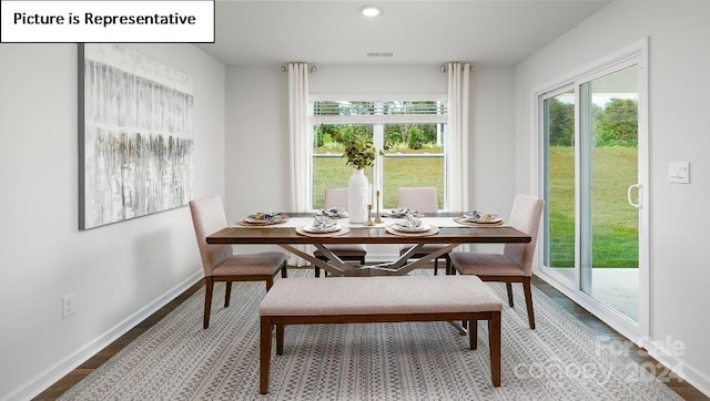 dining area featuring plenty of natural light and hardwood / wood-style flooring