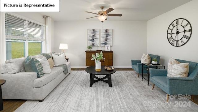 living room with wood-type flooring and ceiling fan