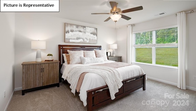 bedroom with ceiling fan and light carpet