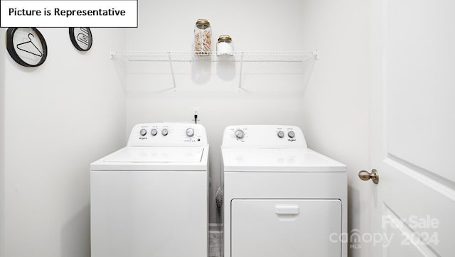 clothes washing area featuring separate washer and dryer