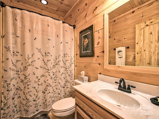 bathroom with toilet, wooden ceiling, vanity, wooden walls, and a shower with shower curtain