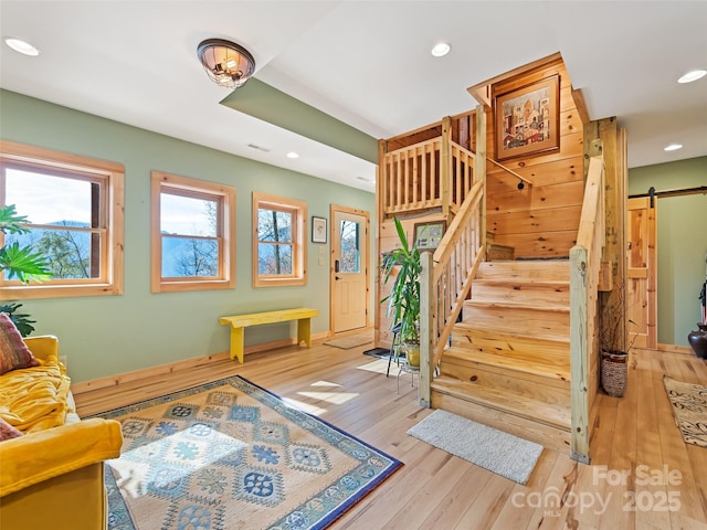 interior space featuring wood-type flooring and a barn door