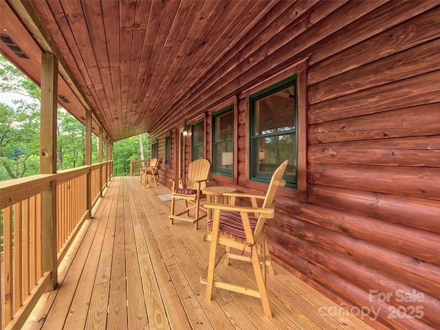 wooden terrace featuring covered porch