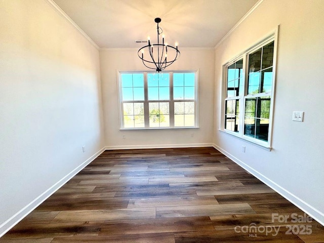 unfurnished dining area featuring a notable chandelier, dark hardwood / wood-style floors, crown molding, and plenty of natural light