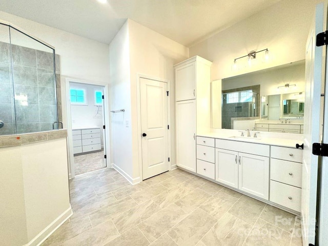 bathroom featuring vanity and a shower with shower door