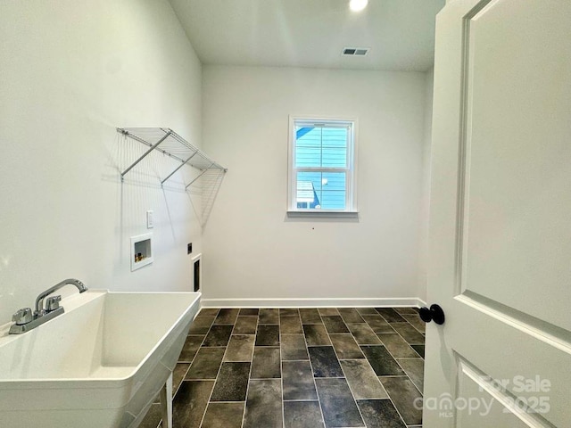 laundry area with hookup for a washing machine, hookup for an electric dryer, and sink