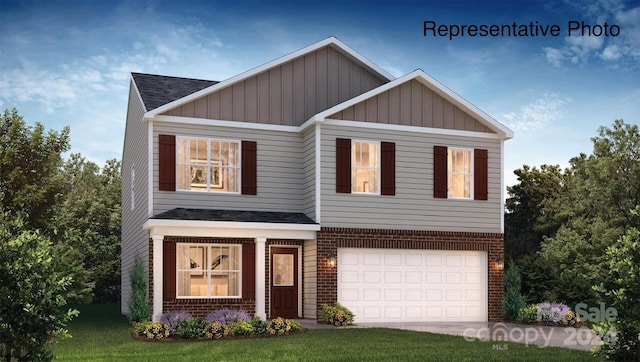 view of front of property featuring a garage and a front lawn