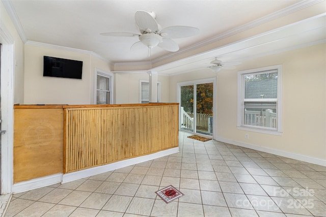 spare room featuring ceiling fan, crown molding, baseboards, and light tile patterned floors