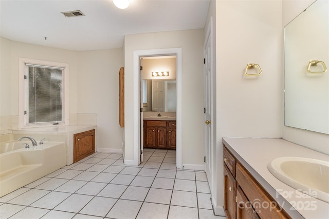 bathroom with tile patterned flooring, visible vents, two vanities, and a sink