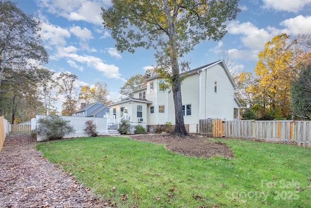 exterior space featuring a front yard and a fenced backyard