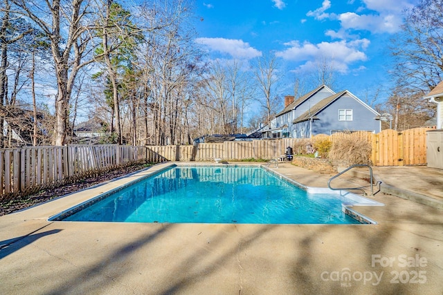 view of swimming pool with a patio area, a fenced backyard, and a fenced in pool