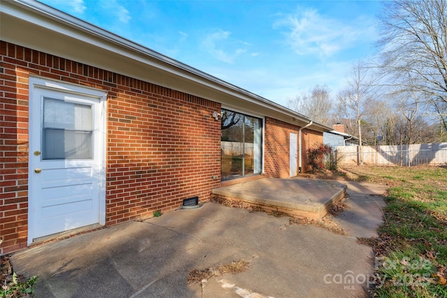 view of side of property with a patio