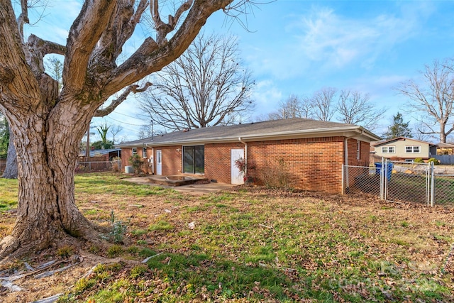 rear view of property featuring a yard