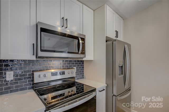 kitchen with light countertops, appliances with stainless steel finishes, and white cabinetry