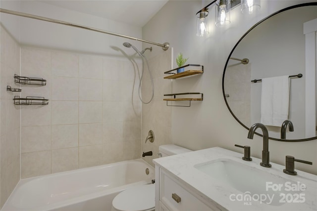 bathroom with tub / shower combination, vanity, and toilet