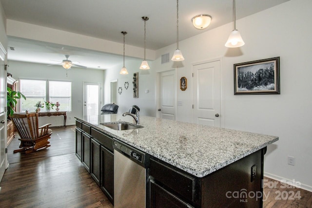 kitchen featuring dishwasher, decorative light fixtures, a center island with sink, and sink