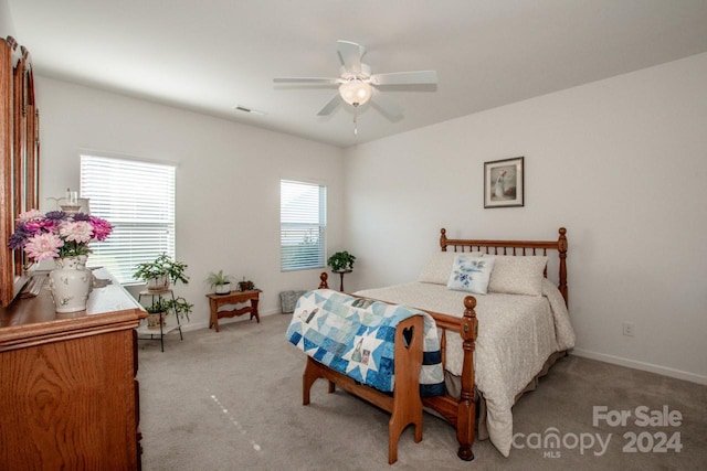 bedroom with light carpet and ceiling fan