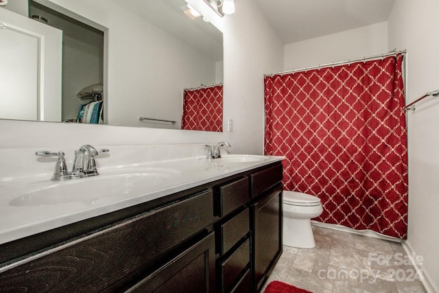 bathroom with vanity, a shower with shower curtain, and toilet