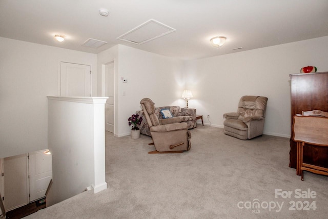 sitting room featuring light colored carpet