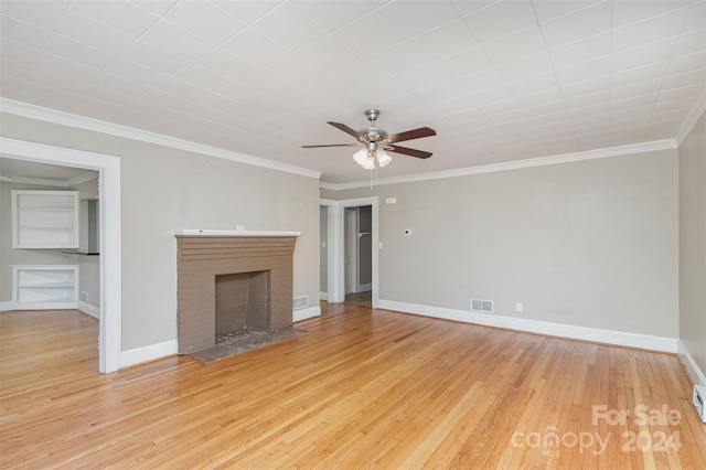 unfurnished living room featuring ceiling fan, crown molding, wood-type flooring, and a fireplace