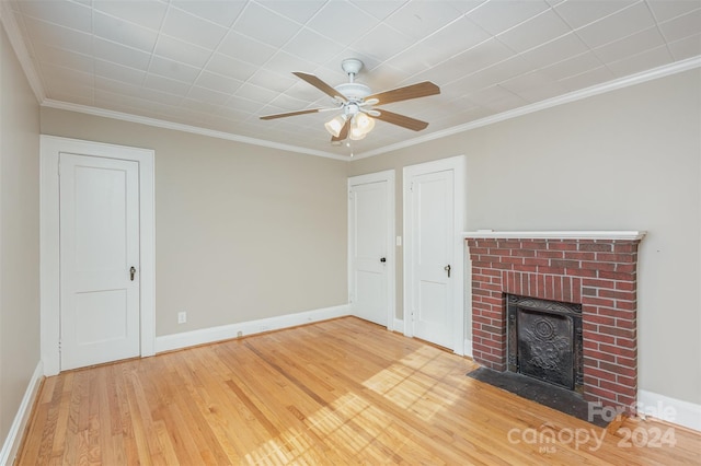 unfurnished living room featuring crown molding, a fireplace, ceiling fan, and hardwood / wood-style flooring